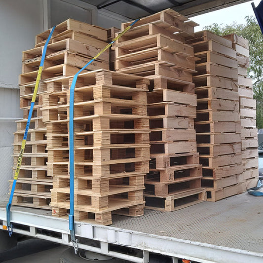 Small skid pallets strapped on a truck
