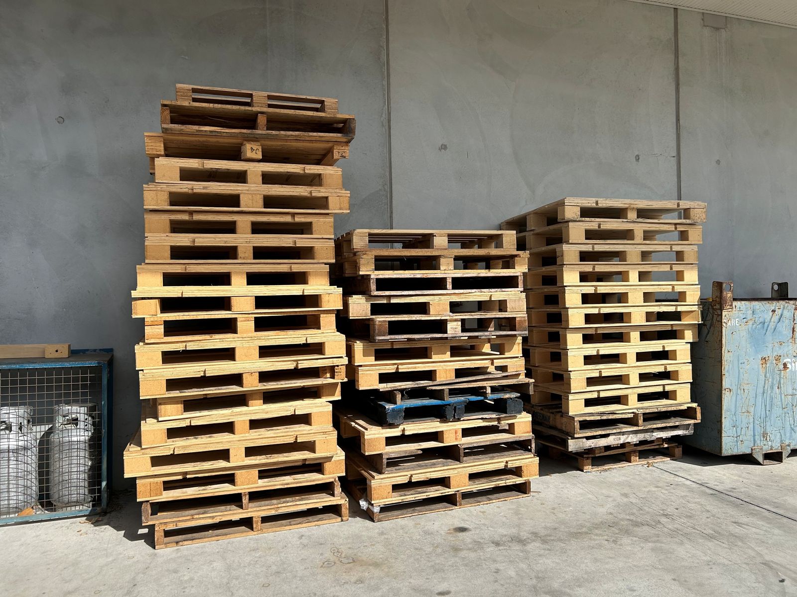 Neat stacks of used pallets ready for collection