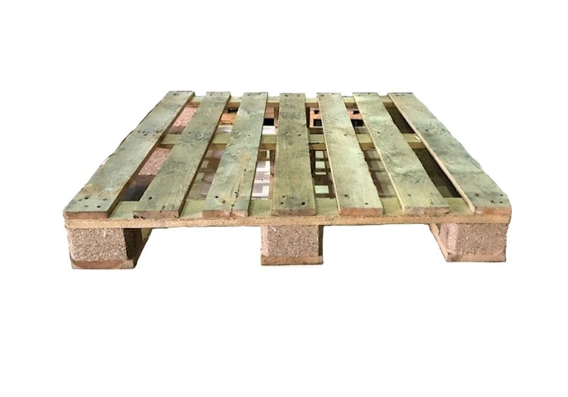 A rectangular timber pallet on chipboard blocks